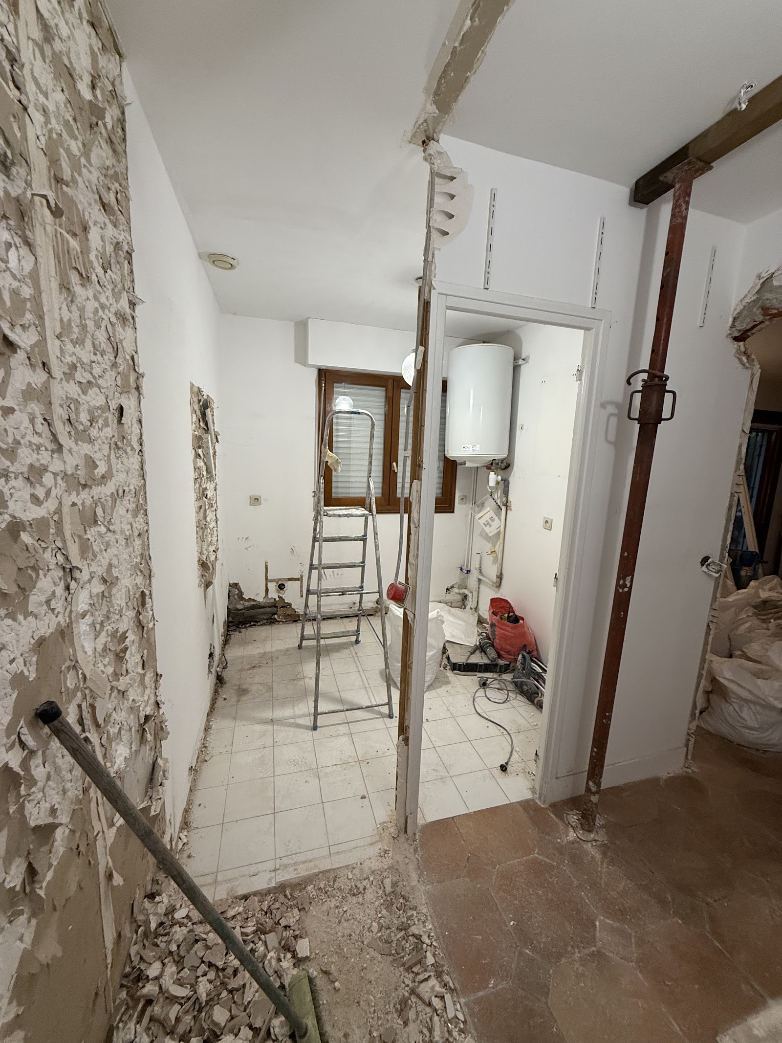 A property mid-renovation — walls stripped back ready for first-fix plumbing, heating and building work.